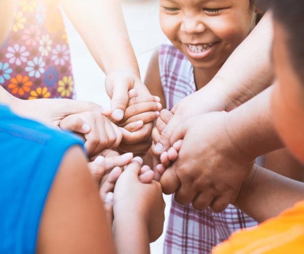 Children and parent holding hands and playing together with unit Children and parent holding hands and playing together with unity and teamwork